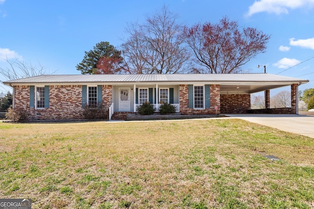 single story home with a front yard, driveway, a carport, brick siding, and metal roof