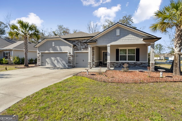 view of front of house featuring a garage, a front yard, concrete driveway, and stone siding