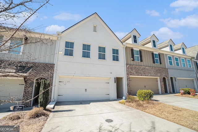 townhome / multi-family property featuring concrete driveway, brick siding, and an attached garage