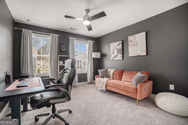 carpeted office space featuring a ceiling fan, visible vents, and baseboards