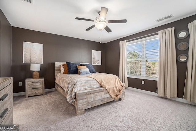 bedroom featuring light carpet, baseboards, visible vents, and ceiling fan