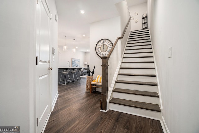 stairs featuring recessed lighting, baseboards, and wood finished floors