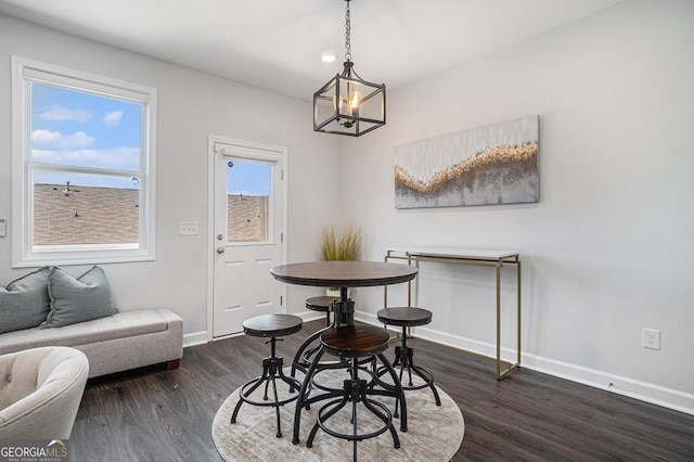 dining space with dark wood-style floors and baseboards