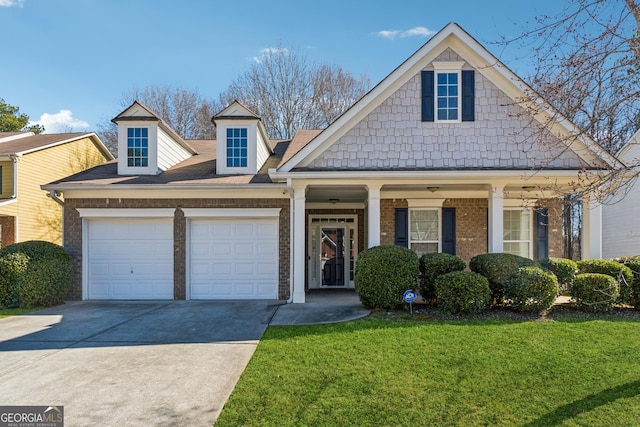 view of front facade with an attached garage, brick siding, driveway, and a front yard