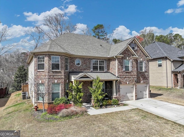 view of front of property with driveway, brick siding, a shingled roof, an attached garage, and a front yard