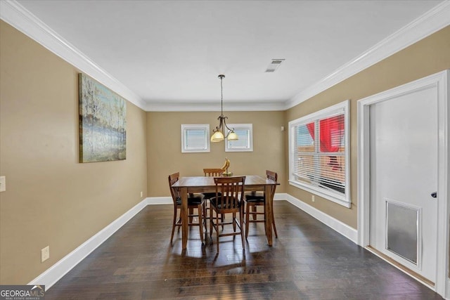 dining area with dark wood-style flooring, crown molding, a notable chandelier, visible vents, and baseboards