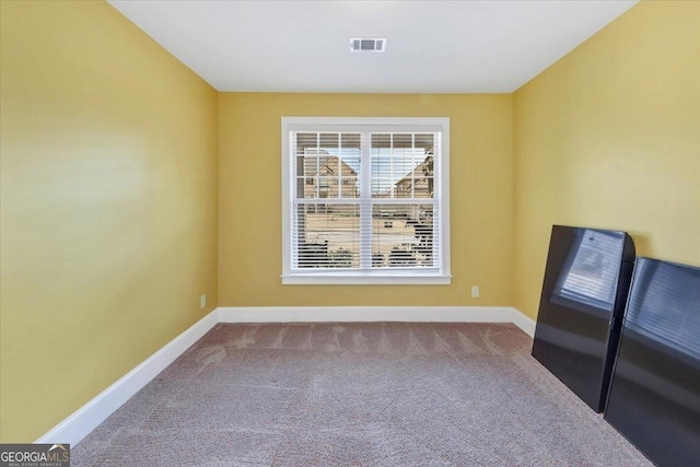 carpeted empty room featuring visible vents and baseboards