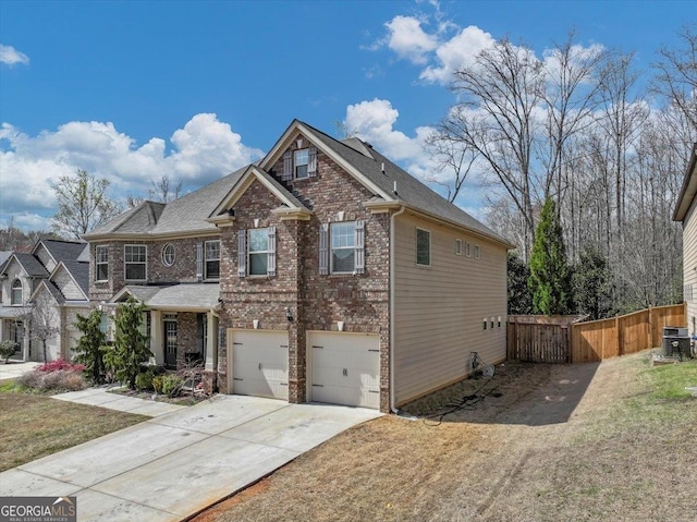 view of front of home with a garage, central AC, brick siding, fence, and driveway