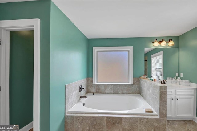 bathroom featuring vanity and a bath