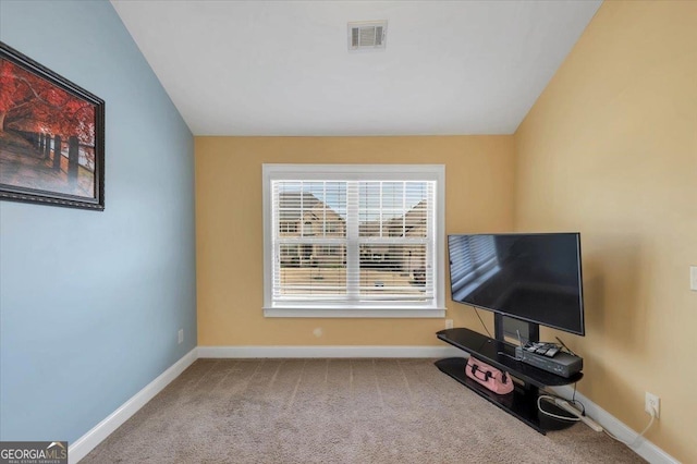 carpeted living area featuring visible vents, vaulted ceiling, and baseboards