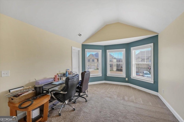 unfurnished office featuring carpet floors, baseboards, visible vents, and vaulted ceiling