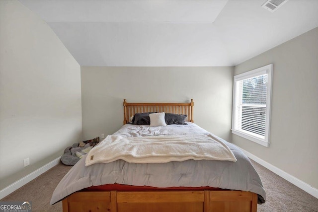 carpeted bedroom featuring visible vents and baseboards