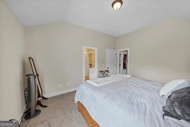 bedroom featuring carpet floors, baseboards, and lofted ceiling