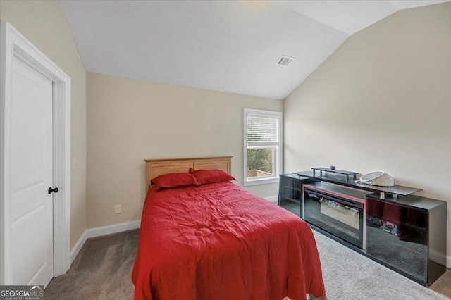 carpeted bedroom with lofted ceiling, visible vents, and baseboards