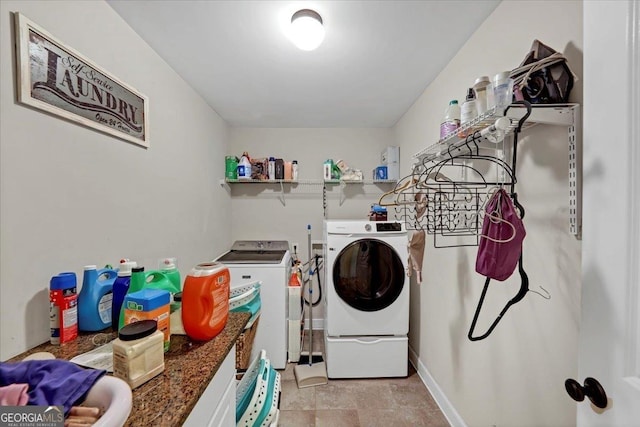 clothes washing area featuring laundry area and washing machine and clothes dryer