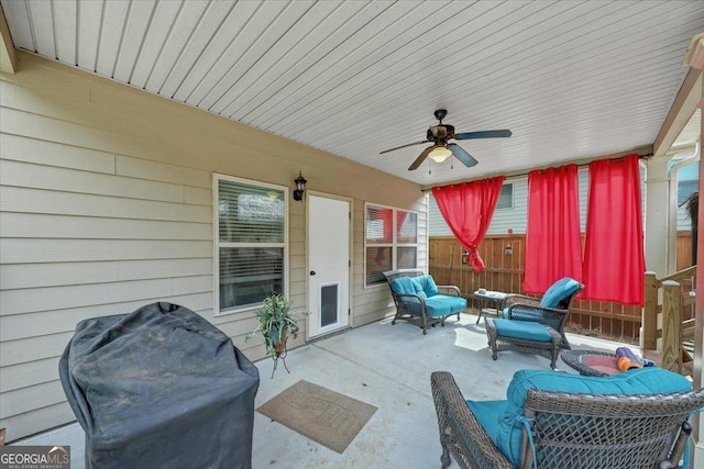 view of patio with ceiling fan, fence, grilling area, and an outdoor living space