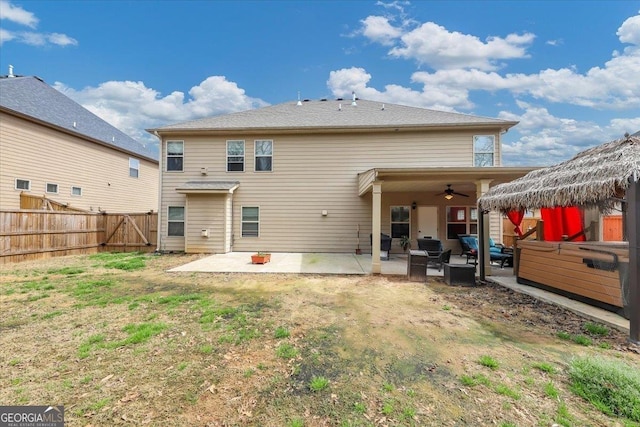 back of house featuring ceiling fan, a patio, a lawn, and a fenced backyard