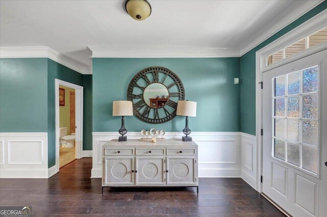 interior space featuring ornamental molding, wainscoting, and dark wood finished floors