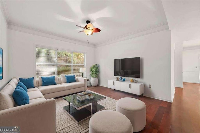 living area featuring wood finished floors, a ceiling fan, and crown molding