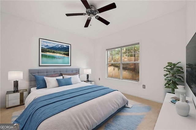 bedroom featuring light carpet and ceiling fan