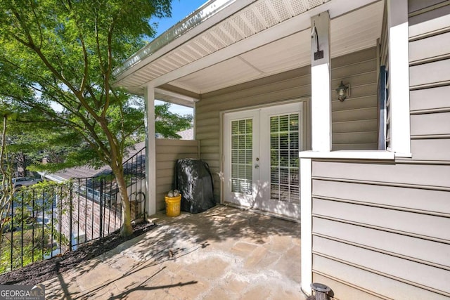 view of patio featuring french doors and fence