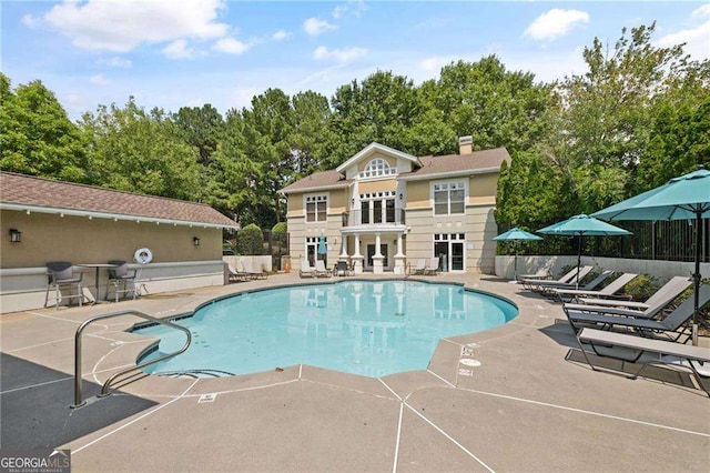 pool featuring a patio and fence