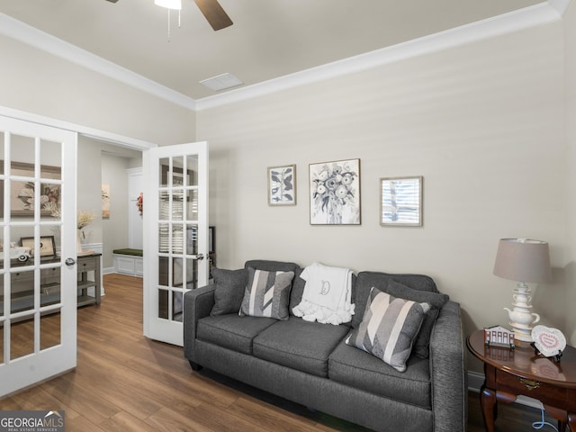 living area with ceiling fan, french doors, wood finished floors, and crown molding