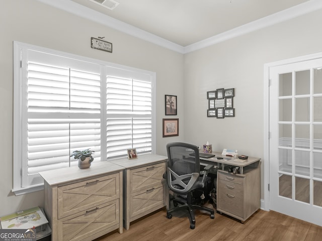 office featuring light wood-style floors and crown molding