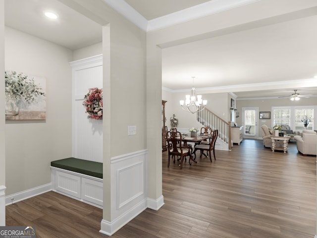 interior space featuring crown molding, dark wood finished floors, baseboards, and an inviting chandelier