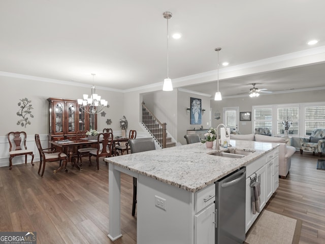 kitchen with wood finished floors, a sink, white cabinetry, open floor plan, and dishwasher