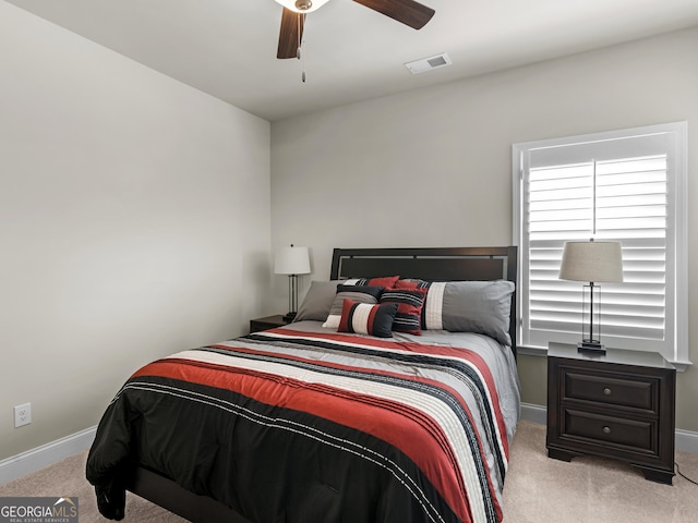 bedroom featuring a ceiling fan, carpet, visible vents, and baseboards