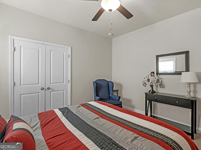 carpeted bedroom with ceiling fan, a closet, and baseboards