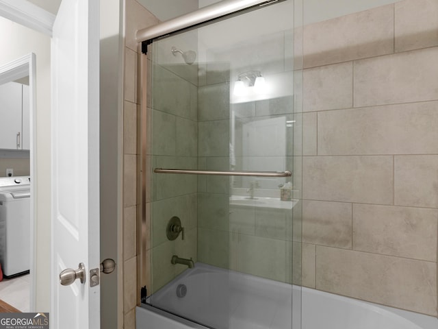 full bathroom with shower / bath combination with glass door and washer / clothes dryer