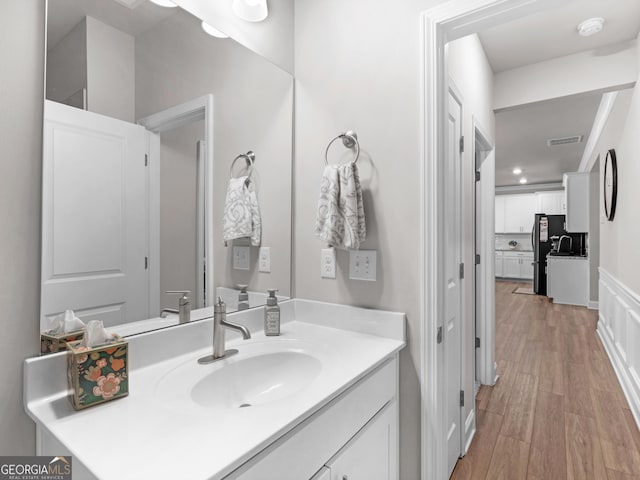 bathroom with vanity, wood finished floors, and visible vents