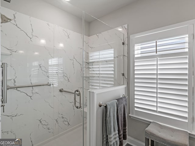 bathroom with a marble finish shower