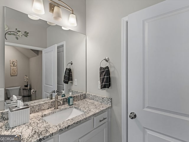 bathroom featuring toilet and vanity