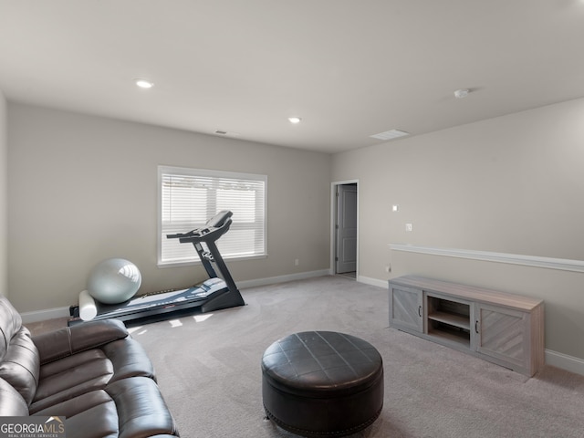 exercise area with recessed lighting, light colored carpet, and baseboards