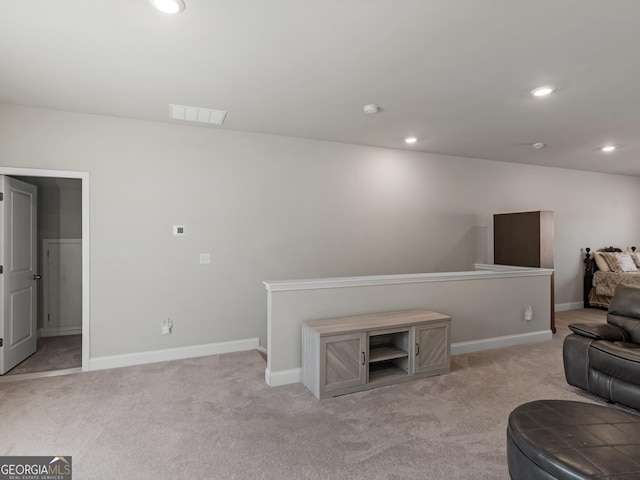 living room with baseboards, recessed lighting, visible vents, and light colored carpet