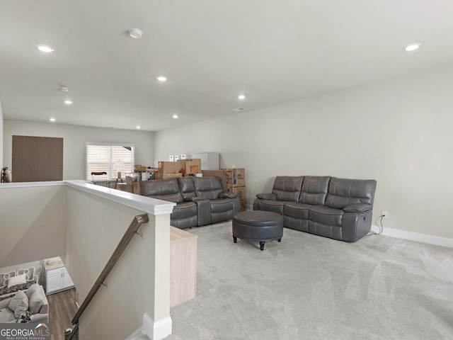 living area with recessed lighting, light colored carpet, and baseboards