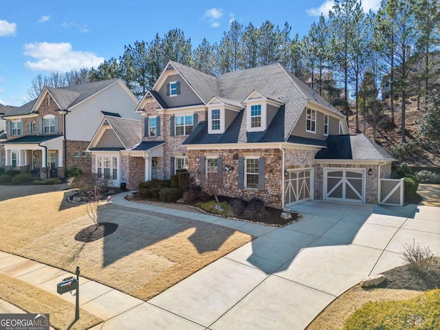 view of front facade with driveway, a garage, a residential view, and roof with shingles