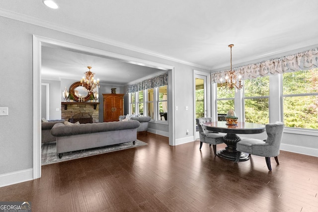 dining area with ornamental molding, dark wood finished floors, and a notable chandelier