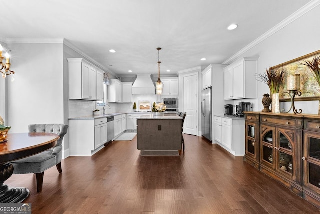 kitchen featuring dark wood-style floors, a kitchen island, appliances with stainless steel finishes, custom exhaust hood, and crown molding