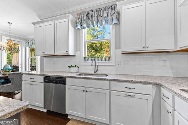 kitchen with a sink, a healthy amount of sunlight, ornamental molding, and dishwasher