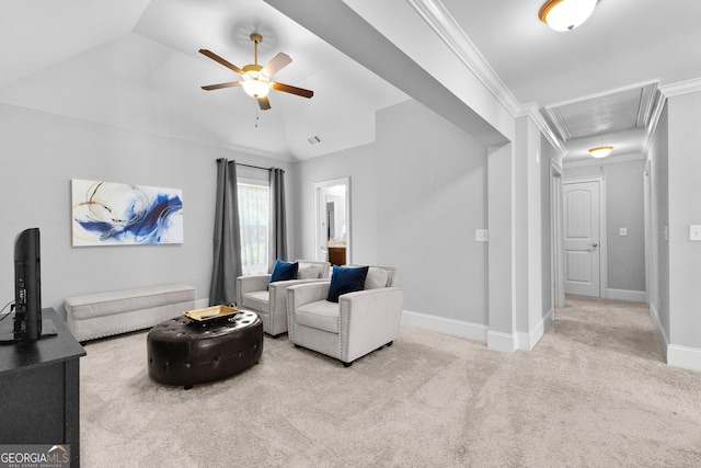 living area featuring lofted ceiling, ornamental molding, carpet, and attic access