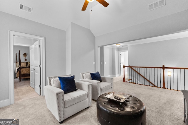 sitting room with vaulted ceiling, an upstairs landing, visible vents, and light colored carpet