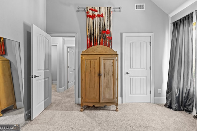 bedroom with light carpet, baseboards, visible vents, and vaulted ceiling