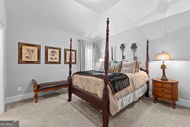 bedroom with light carpet, vaulted ceiling, and baseboards