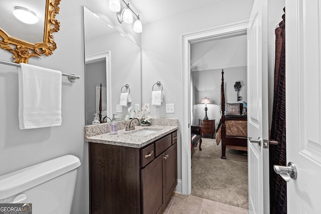 bathroom featuring toilet, ensuite bathroom, and vanity