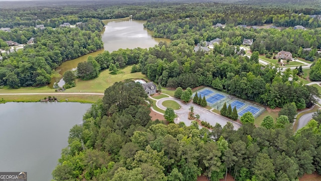 drone / aerial view featuring a water view and a view of trees