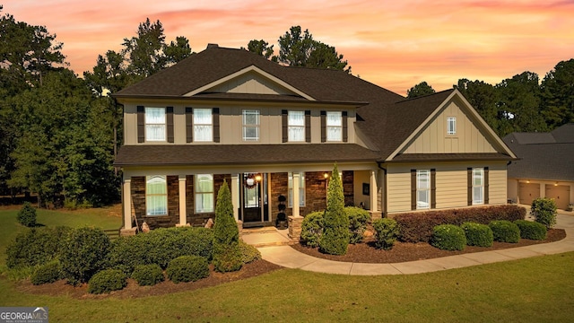 craftsman inspired home with board and batten siding and a lawn